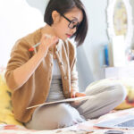 Student Studying on Bed in Room