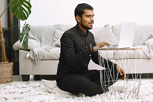 Male Student Sitting on Floor Studying